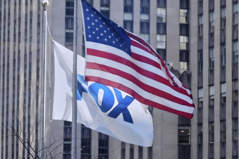 An American flag and a Fox flag fly outside Fox headquarters.