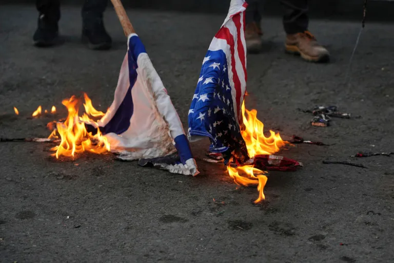 A group of students burn the U.S. and Israeli flags in Tehran, Iran.