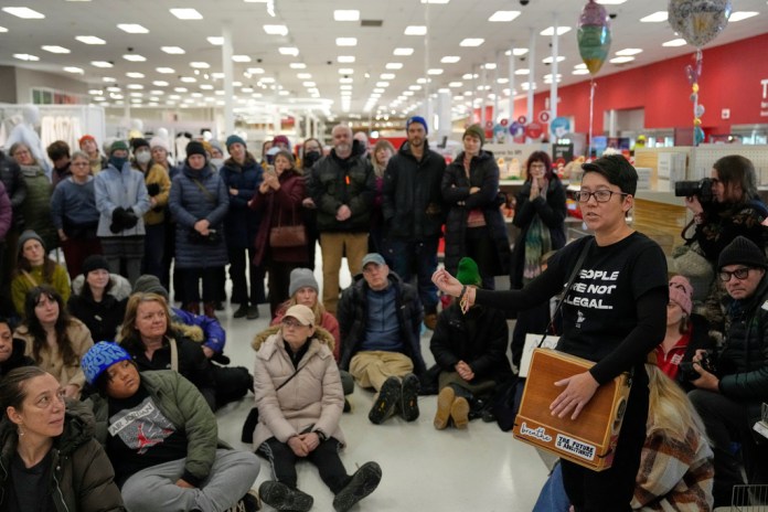 Community members and neighbors of people detained by ICE protest at a Target.