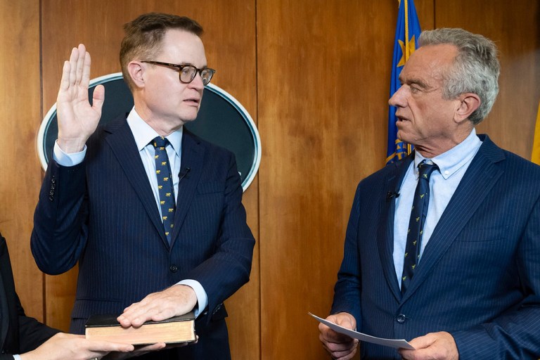 In this photo provided by the Department of Health and Human Secretary, Robert F. Kennedy, Jr., right, conducts the swearing-in ceremony of Jim O'Neill as the Department's Deputy Secretary, June 9, 2025, in Washington. (Amy Rossetti/Department of Health and Human Services via AP)
