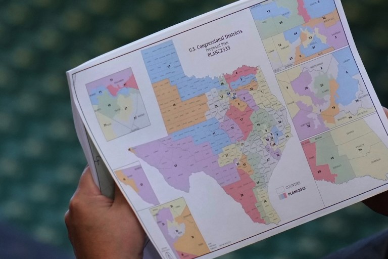 Texas state Sen. Pete Flores, R-Pleasanton, looks over a redrawn U.S. congressional map during debate over a bill in the Senate Chamber at the Texas Capitol in Austin, Texas, Aug. 22, 2025. (AP Photo/Eric Gay, File)