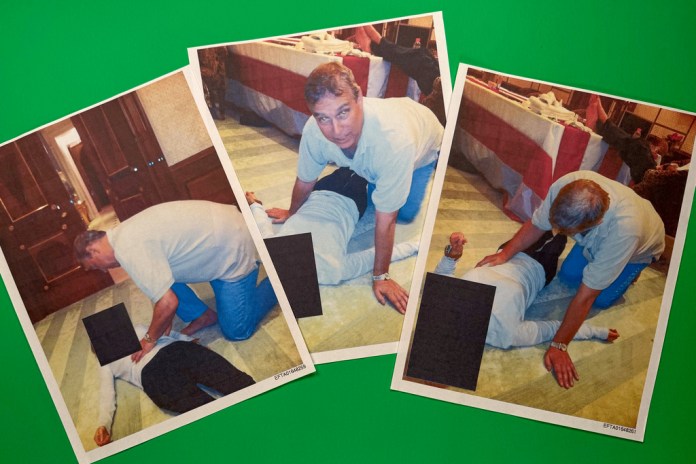 Photos from release of Epstein files show Prince Andrew hovering over female minor laid out on the floor