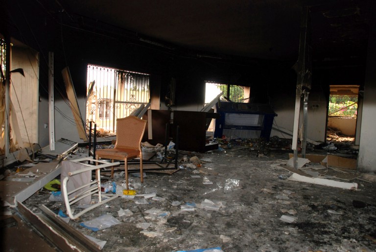FILE - Glass, debris and overturned furniture are strewn inside a room in the gutted U.S. consulate in Benghazi, Libya, after an attack that killed four Americans, including Ambassador Chris Stevens., Sept. 12, 2012. (AP Photo/Ibrahim Alaguri, File)