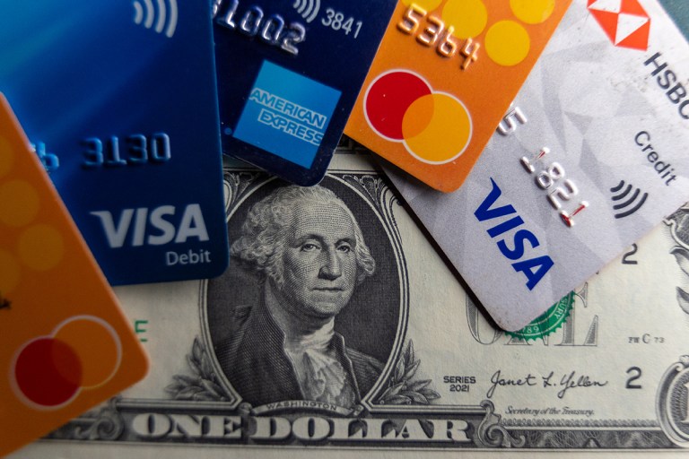 In this photo illustration the Visa, Mastercard and American Express logo on various credit cards and debit cards are seen beside US one dollar bills on February 4, 2025 in Somerset, England. A recent Senate hearing heard of the large profits companies such as Mastercard and Visa were making while the US grapples with a record amount of credit card debt. (Photo by Anna Barclay/Getty Images)