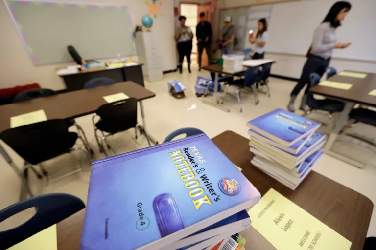 Notebooks are stacked on desks in a classroom at A.G. Hilliard Elementary School, Saturday, Sept. 2, 2017, in Houston. (AP Photo/David J. Phillip, File)