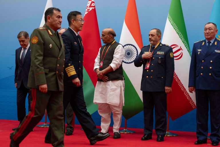 Chinese Defense Minister Dong Jun, third left, walks near Iran Defense Minister Aziz Nasirzadeh.