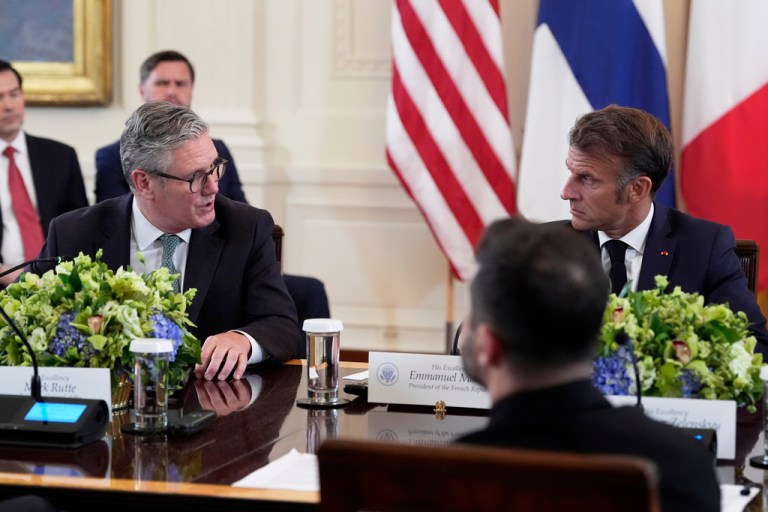 British Prime Minister Keir Starmer speaks as France's President Emmanuel Macron listens during a meeting with Ukrainian President Volodymyr Zelenskyy, in foreground, President Donald Trump and European leaders in the East Room of the White House, Monday, Aug. 18, 2025, in Washington.