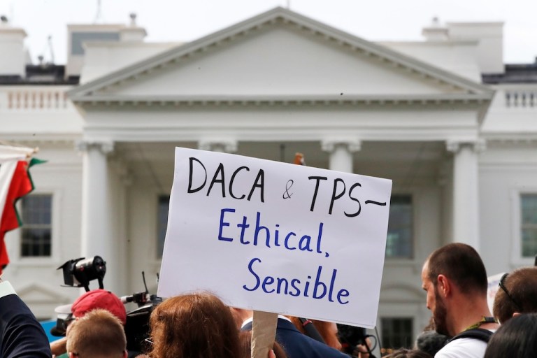 FILE - A person holds up a sign in support of the Deferred Action for Childhood Arrivals, known as DACA, and Temporary Protected Status programs during a rally in support of DACA and TPS outside of the White House, in Washington, Sept. 5, 2017. (AP Photo/Jacquelyn Martin, file)