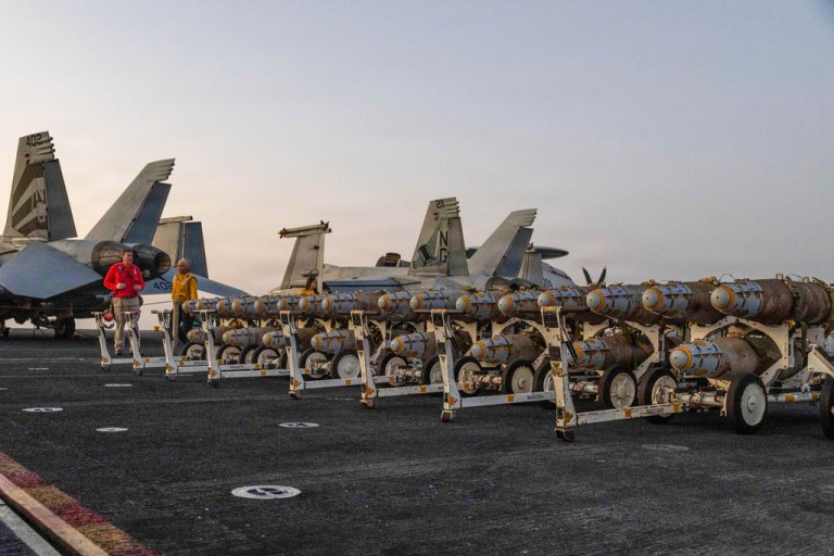 This image provided by U.S. Central Command shows Navy sailors transferring ordnance