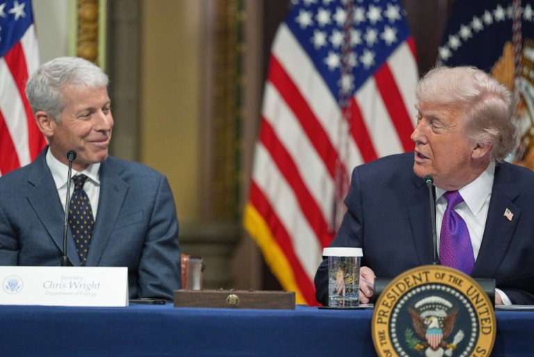 Energy Secretary Chris Wright sitting on the left side of President Donald Trump