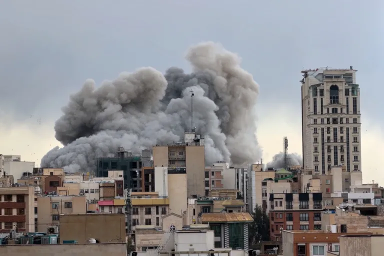 A plume of smoke rises after a strike in Tehran, Iran.