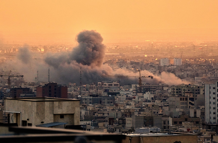 A plume of smoke rises following a U.S.-Israeli military strike in Tehran, Iran on March 3, 2026.