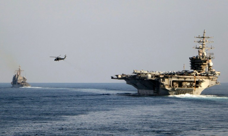 The aircraft carrier USS Dwight D. Eisenhower and other warships crosses the Strait of Hormuz into the Persian Gulf on Sunday, Nov. 26, 2023, as part of a wider American deployment in the Middle East amid the Israel-Hamas war. The Eisenhower was accompanied by the guided-missile cruiser USS Philippine Sea, the guided-missile destroyers USS Gravely and the USS Stethem and the French frigate Languedoc. (Information Technician Second Class Ruskin Naval/U.S. Navy via AP)