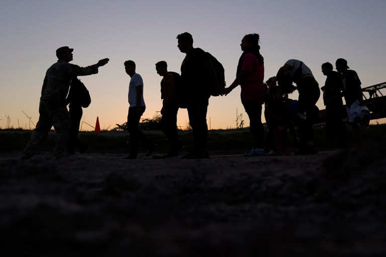 Migrants lined up for processing by U.S. Customs and Border Protection.