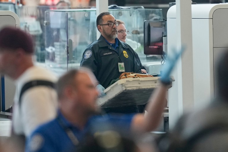 TSA officers work at a security checkpoint at George Bush Intercontinental Airport Friday, March 27, 2026, in Houston.