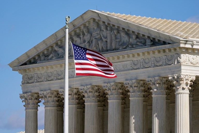 An American flag waves in front of the Supreme Court building on Capitol Hill in Washington, on Nov. 2, 2020.