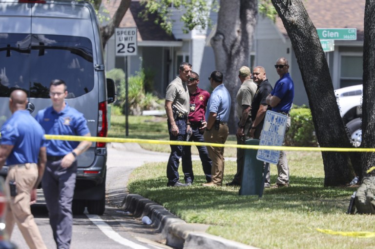 Detectives with the Hillsborough County Sheriff's Office join an investigation inside the Lake Forest subdivision of Tampa, Fla.