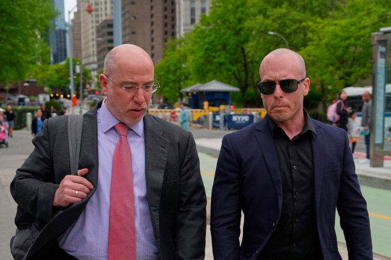 Gannon Ken Van Dyke walks with his attorney in New York.