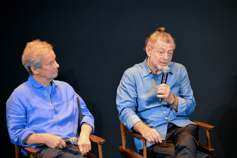 Andy Serkis (R) speaks about his new film, Animal Farm, with business partner Jonathan Cavendish during a fireside chat with Scott Jennings (not pictured).