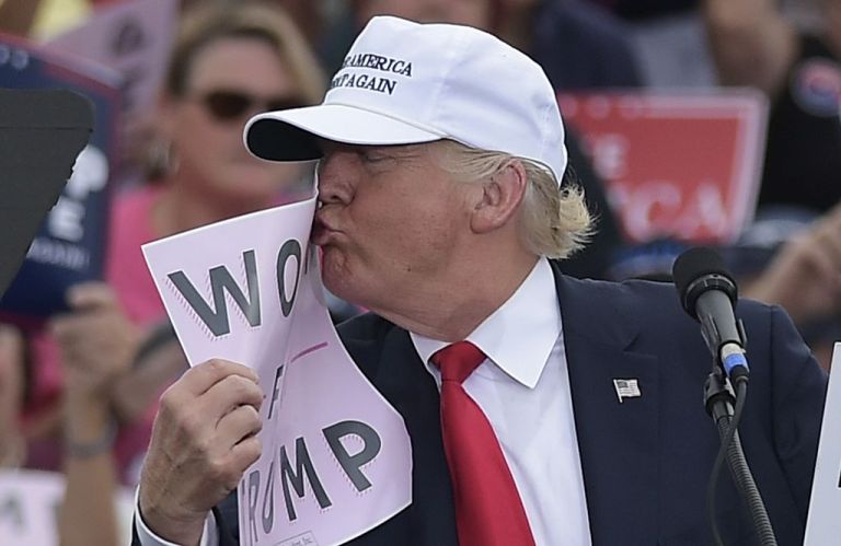 Republican presidential nominee Donald Trump kisses a 