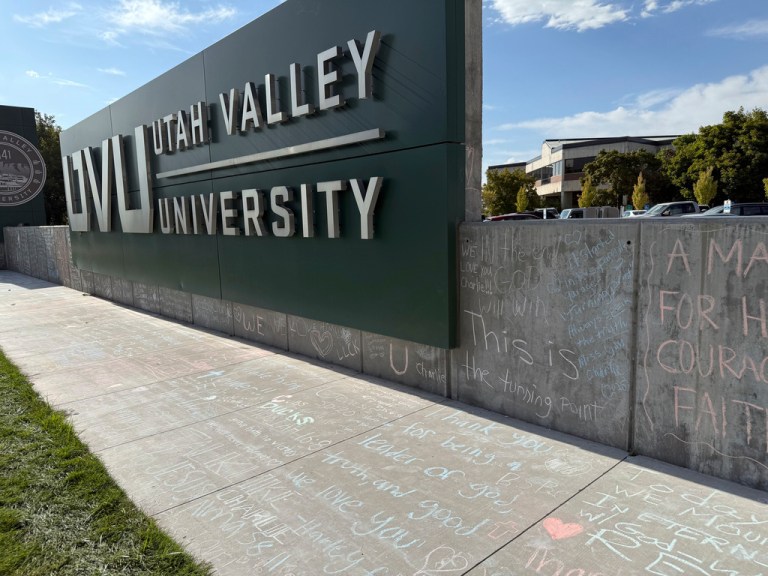 People who brought flowers also wrote messages in chalk at a memorial for Charlie Kirk, who was shot and killed last week, at Utah Valley University.