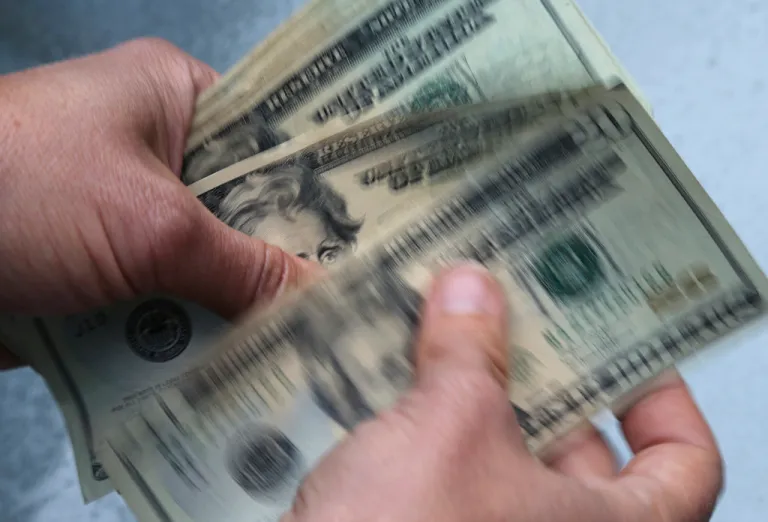 $20 bills being counted.