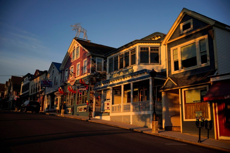 Early-morning light shines on shops.