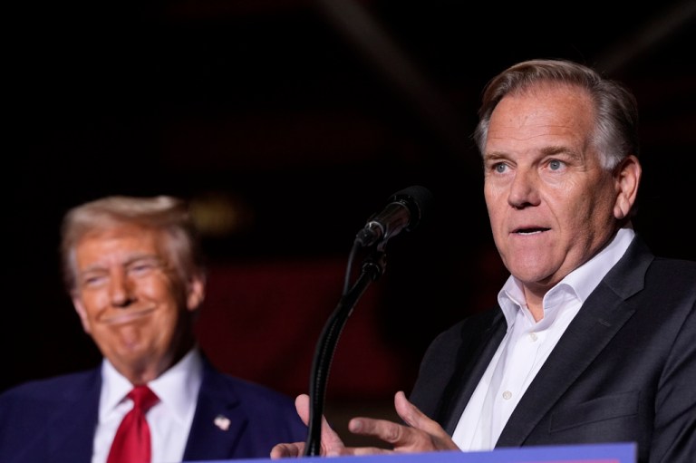 Republican presidential nominee former President Donald Trump listens as Senate candidate former Rep. Mike Rogers, speaks at a campaign event at the Ryder Center at Saginaw Valley State University, Thursday, Oct. 3, 2024, in University Center, Mich. (AP Photo/Alex Brandon)