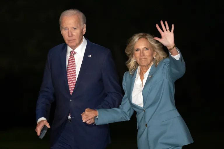 President Joe Biden and first lady Jill Biden walk across the South Lawn