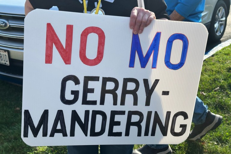 A person holds a sign opposing the new U.S. House districts passed by the Missouri General Assembly.