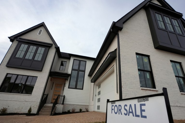 A for sale sign is posted outside a home