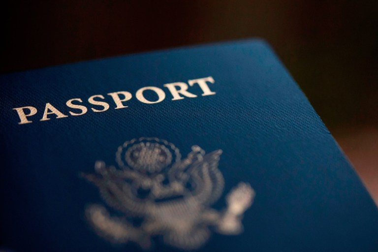 The cover of a U.S. Passport is displayed in Tigard, Ore., Dec. 11, 2021. (AP Photo/Jenny Kane)