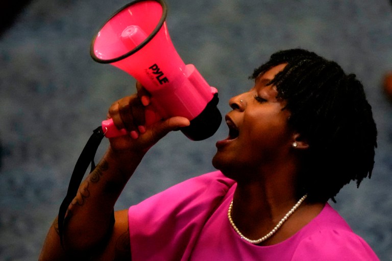 Angie Nixon yelling into a megaphone