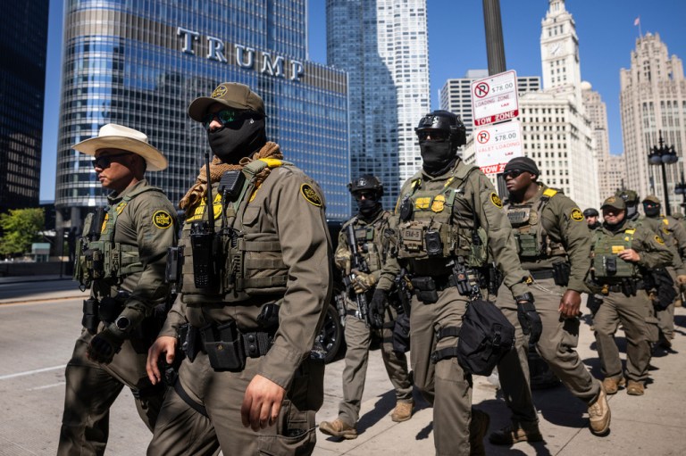 Federal agents from U.S. Immigration and Customs Enforcement and U.S. Customs and Border Protection walk