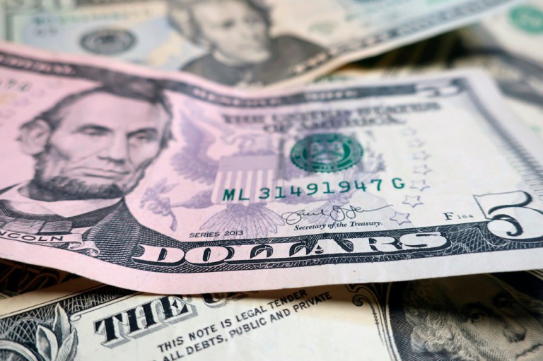 Dollar bills piled on top of each other