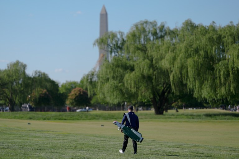 The Washington Monument stands in the background as a golfer walks the East Potomac Golf Course, Sunday, May 3, 2026, in Washington. (AP Photo/Julia Demaree Nikhinson)