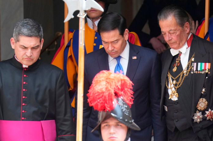Rubio walks beside clerics and gentlemen of His Holiness at the Vatican