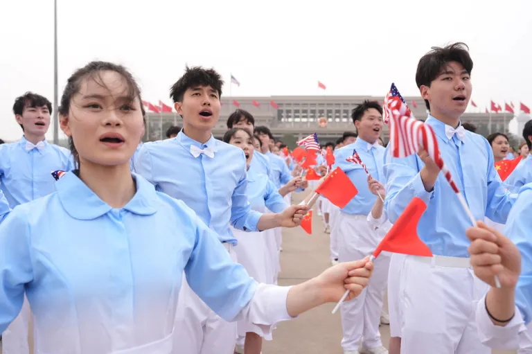 Chinese youth performers perform as President Donald Trump boards Air Force One.