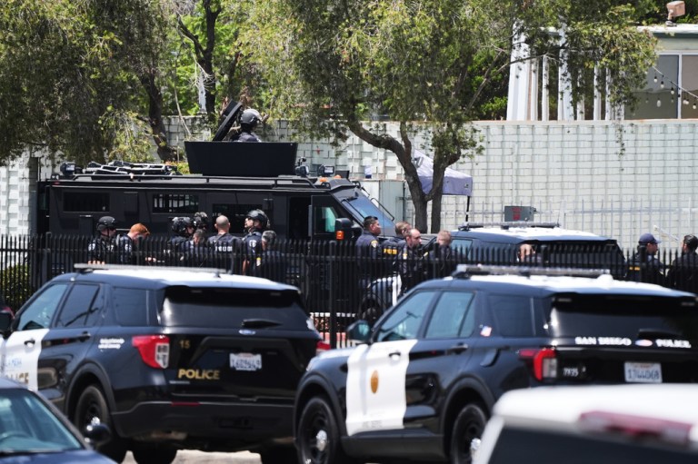Police stage at the scene of a shooting outside the Islamic Center of San Diego.