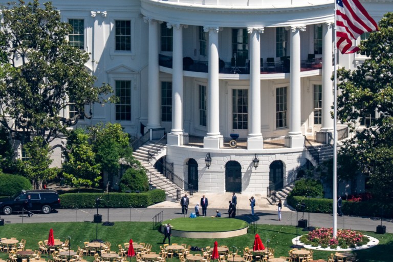 President Donald Trump, center, stops to look at the set-up of tables and chairs on the South Lawn of the White House in Washington in preparation for tonight's Congressional Picnic, Tuesday, May 19, 2026.