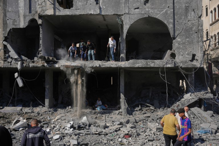 Palestinians inspect the rubble of a building destroyed in an Israeli airstrike in Nuseirat, central Gaza Strip, Tuesday, May 26, 2026.