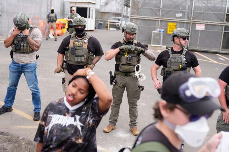 Federal agents stand outside the Delaney Hall detention center during a protest against the transfer of detainees on Wednesday, May 27, 2026, in Newark, N.J. (AP Photo/Seth Wenig)