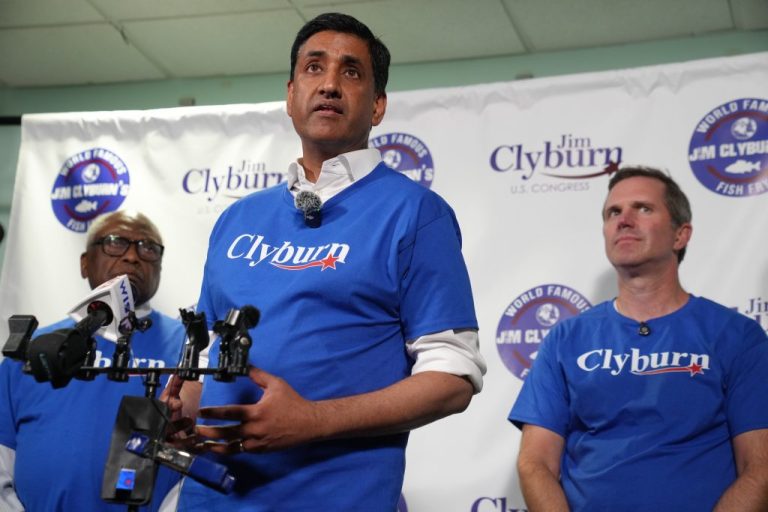 U.S. Rep. Ro Khanna (D-CA), center, speaks to reporters as U.S. Rep. Jim Clyburn (D-SC) and Democratic Gov. Andy Beshear of Kentucky look on.