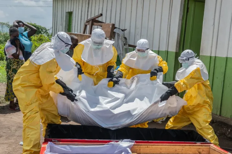 Red Cross workers cary body of person who died from Ebola in Congo.