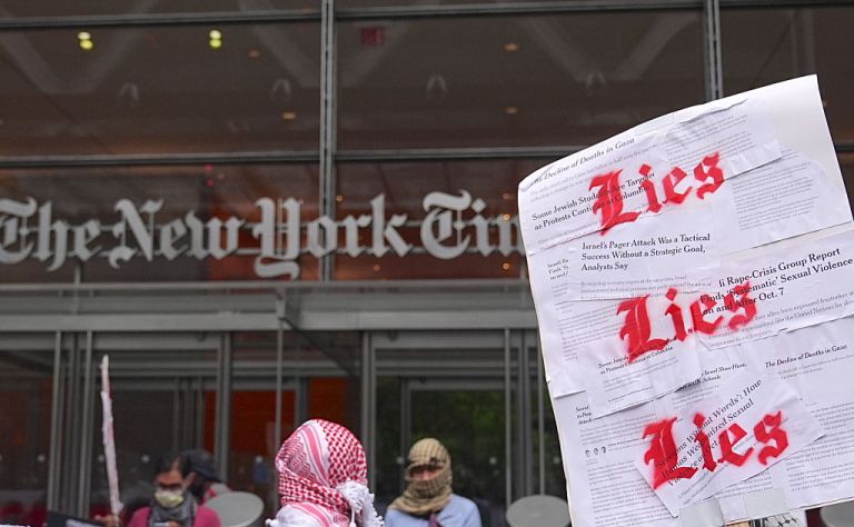 Pro-Palestinians gathered in front of the New York Times building, holding banners to protest the newspaper for pro-Israeli bias in its coverage, in New York, United States, on June 17, 2025. (Photo by Selcuk Acar/Anadolu via Getty Images)