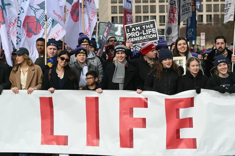 People hold a giant banner as they march through Pennsylvania Avenue during the 53rd annual March for Life rally.