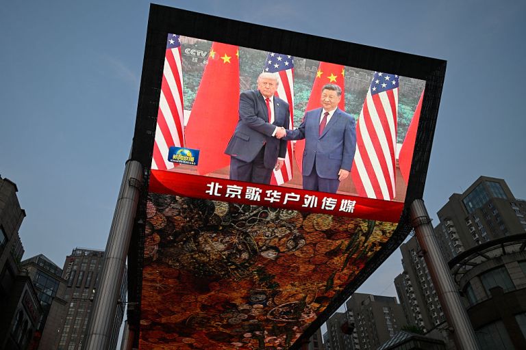 A big screen shows a broadcasting of Chinese President Xi Jinping meeting with US President Donald Trump at the Great Hall of the People in Beijing on May 14, 2026. (Photo by WANG Zhao / AFP via Getty Images)