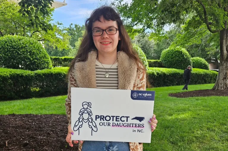 woman holding a sign
