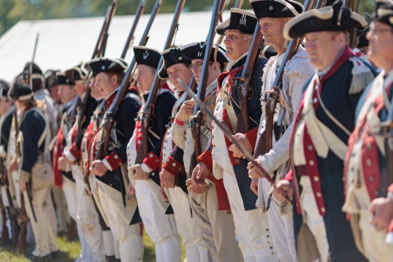 Second Continental Army reenactors depicting readiness activities.