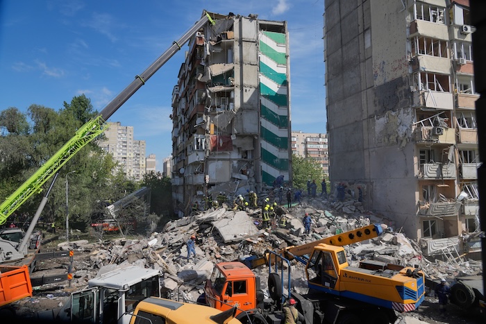 Rescuers clear the rubble after a Russian missile hit an apartment building.